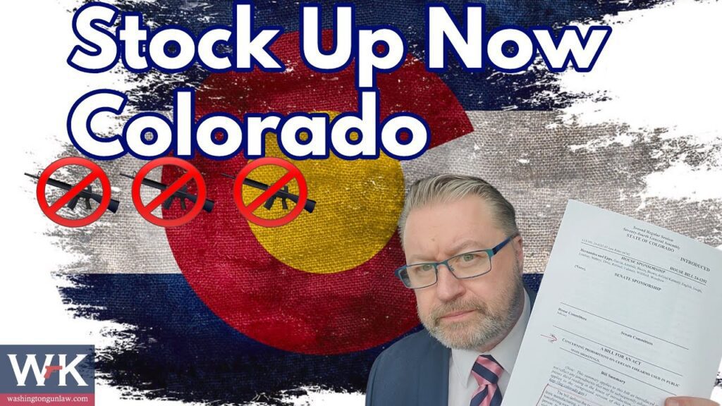 Man in a suit holding a document with an expression of concern, standing in front of a Colorado state flag backdrop. Text reads "Stock Up Now Colorado" with signs depicting a no symbol over a gun, knife, and bullet.
