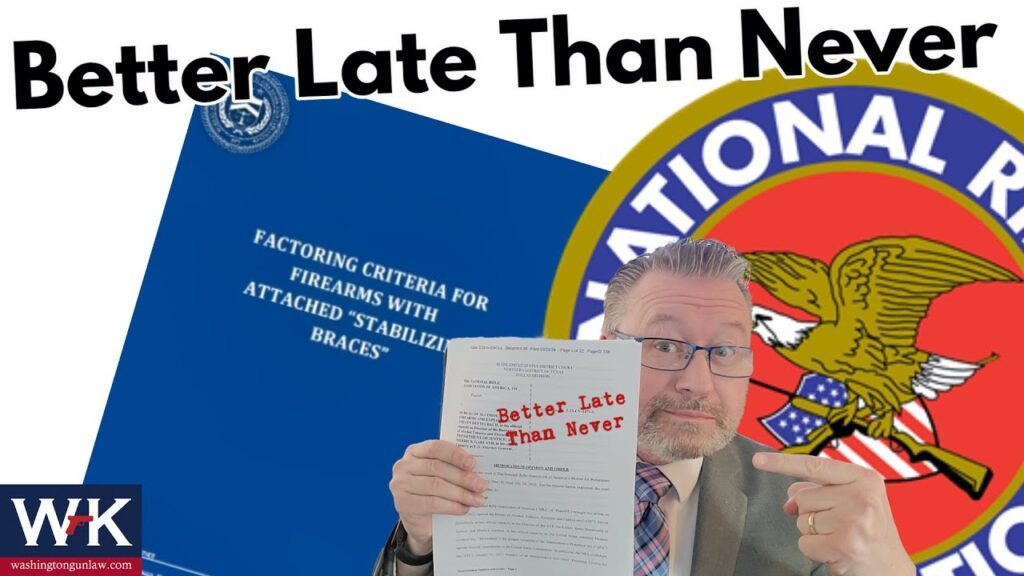A man in glasses and a suit points at a paper labeled "Better Late Than Never," with a background featuring the National Rifle Association logo and a blue document titled "Factoring Criteria for Firearms with Attached 'Stabilizing Braces.'.