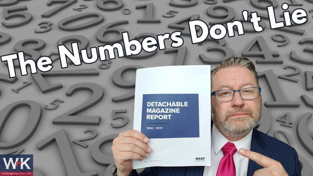 A man in a suit and tie holds a document titled "Detachable Magazine Report 1950-2021" against a background of large numerical digits. The text "The Numbers Don't Lie" is prominently displayed at the top.