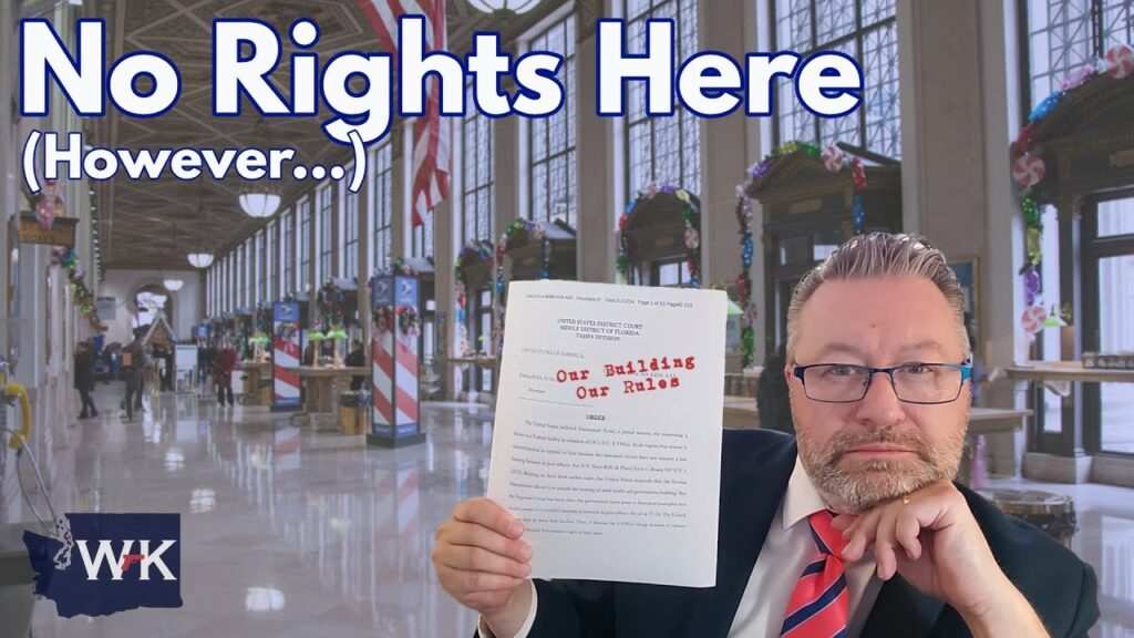 A man in a suit and glasses holds a document with "Our Building Our Rules" in red text. He sits in a large hall decorated with flags and columns. The text "No Rights Here (However...)" is displayed at the top.