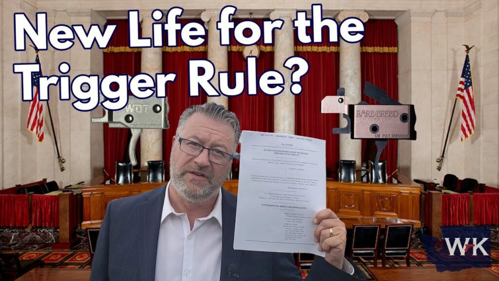 A man stands in a courtroom holding a document. The text above reads, "New Life for the Trigger Rule?" There are images of firearm triggers in the background, and American flags flank the scene.