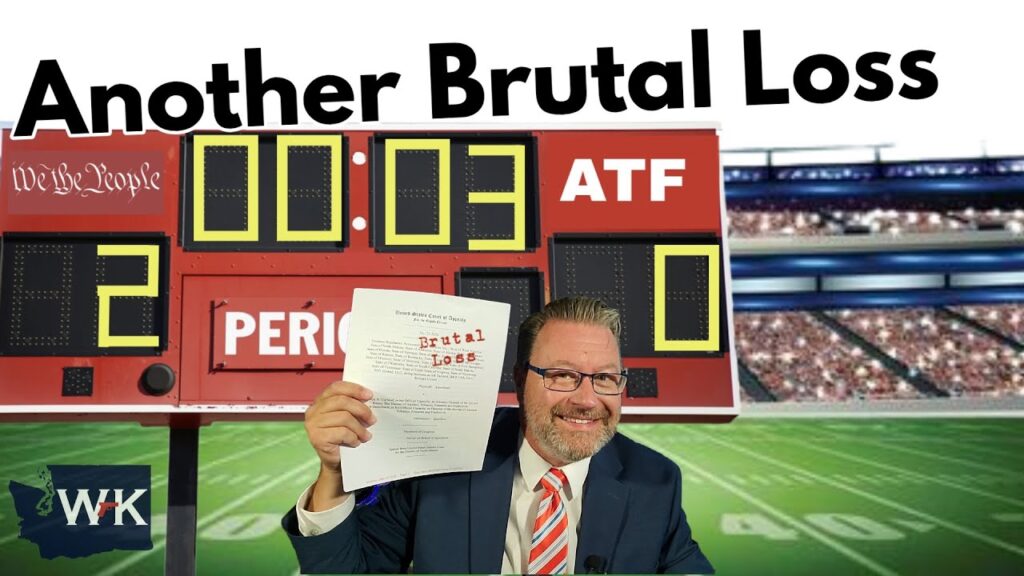 A smiling man in a suit holds up a paper titled "Brutal Loss" in front of a sports scoreboard showing "Another Brutal Loss," with a score of 20-0 and 3 seconds left. Stadium seats are visible in the background.