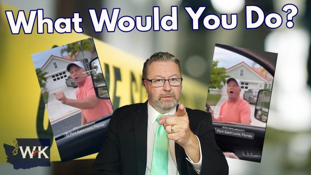 A man in a suit points at the viewer against a backdrop featuring two images of a man in a vehicle. The words "What Would You Do?" are written at the top. The bottom left corner displays the initials "WK" with a silhouette of a state.