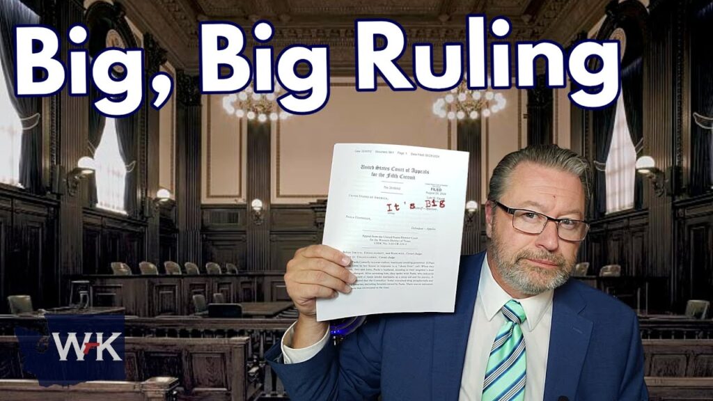 A man in a suit and glasses holds up a document in a courtroom setting. Large text above him reads "Big, Big Ruling." The room features wooden benches and ornamental architecture.