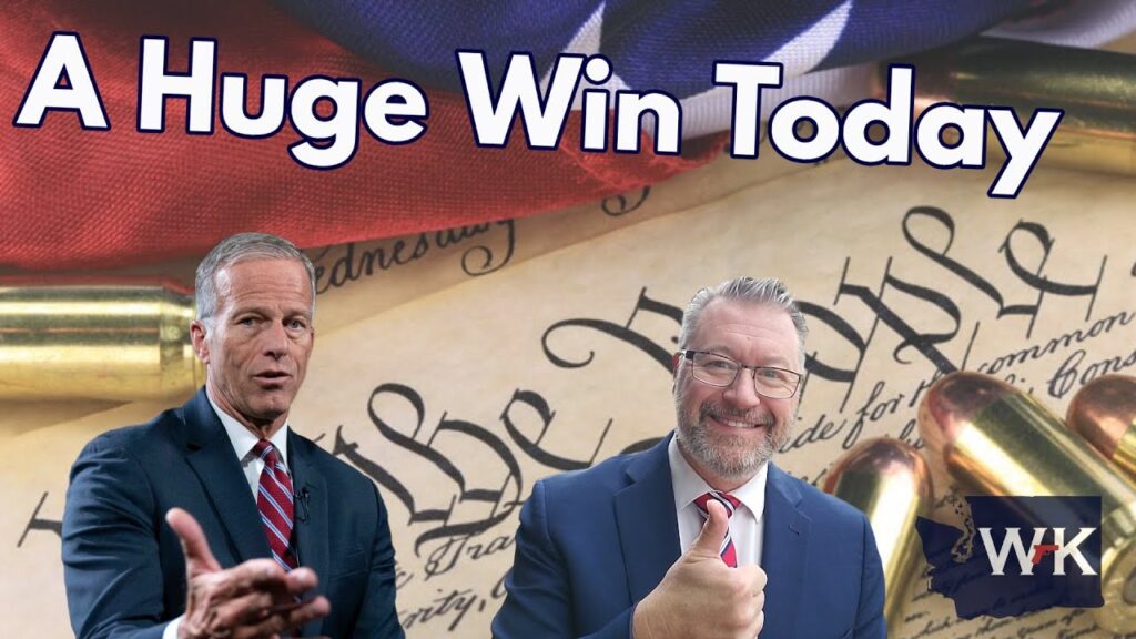 Two men in suits are in front of a U.S. Constitution backdrop with bullets and an American flag. Text reads "A Huge Win Today.