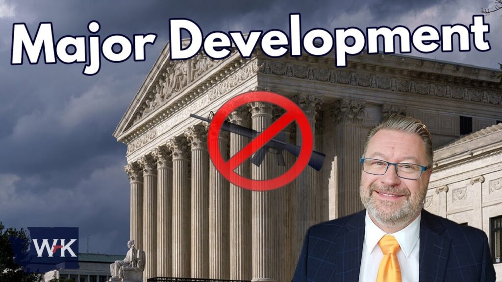 A man in a suit and glasses stands in front of a courthouse with a stormy sky. The words "Major Development" appear at the top, and a crossed-out gun symbol is displayed.