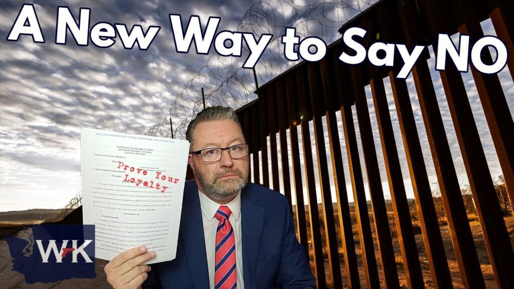 A man in a suit holds a document titled "Prove Your Loyalty." Behind him is a barbed-wire fence with a sunset sky. The text "A New Way to Say NO" is displayed at the top.