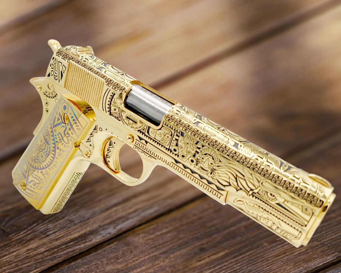 A highly detailed gold-plated handgun with intricate engravings, including geometric and floral patterns, rests on a wooden surface. The handgun's slide is partially open, revealing the chamber.