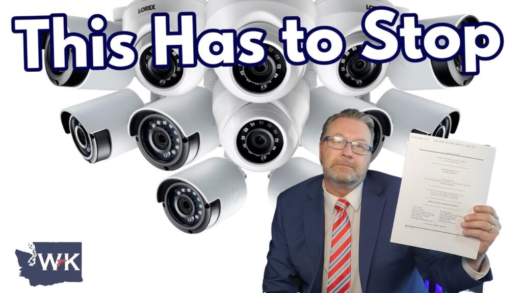 A man in a suit and tie holds up documents in front of a cluster of security cameras. Large text at the top reads, "This Has to Stop." A small logo with "WK" and a state outline is at the bottom left.