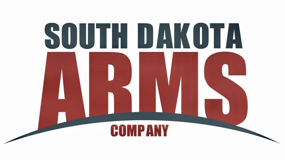 Firearms Training Directory 12 Logo with the words "South Dakota Arms Company." "South Dakota" is in dark green, "ARMS" is large and red, and "Company" is smaller in red below, all set above a curved line.