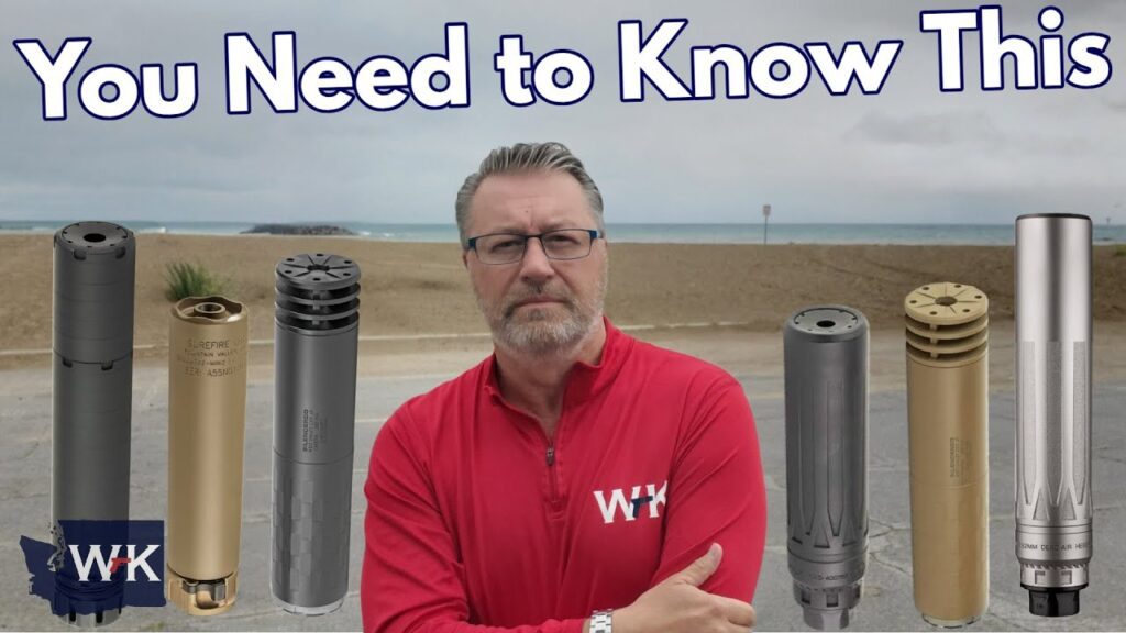 A man in a red WK-branded jacket stands with arms crossed on a beachside road, surrounded by six different firearm suppressors. The text above reads, "You Need to Know This.