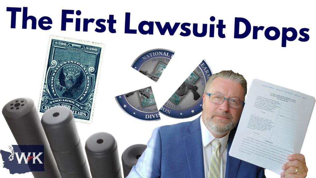 A man in a suit holds up a legal document. The text reads "The First Lawsuit Drops." Surrounding him are images of a $200 tax stamp, segments of a broken seal, and several cylindrical objects. The WK logo is in the corner.