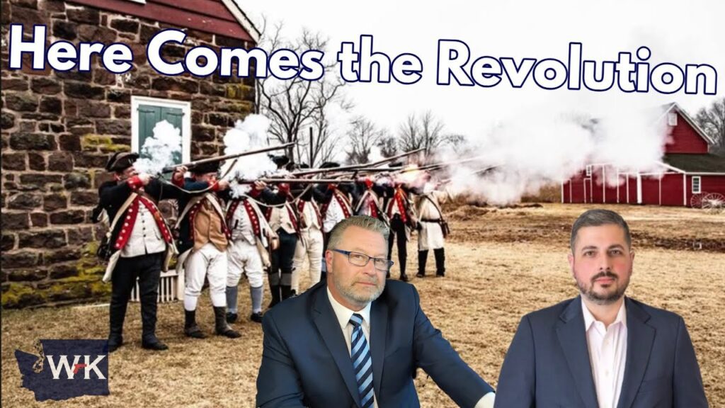 A line of Revolutionary War reenactors in colonial uniforms fire muskets outside a stone building, with two men in suits in the foreground and the text "Here Comes the Revolution" above them.