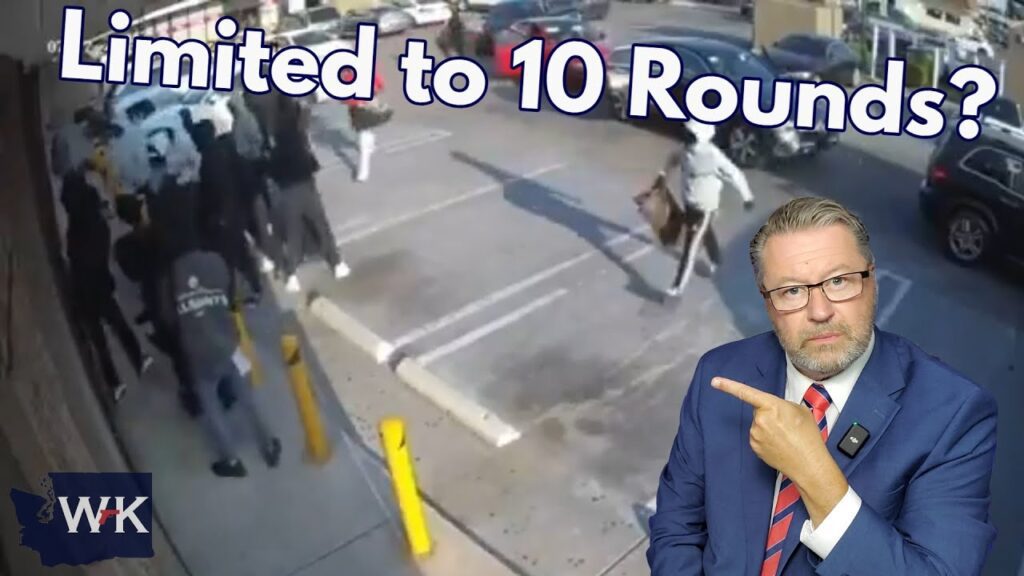 A man in a blue suit and glasses points to a surveillance image showing a chaotic scene with people running in a parking lot. Text reads “Limited to 10 Rounds?” in large letters at the top.
