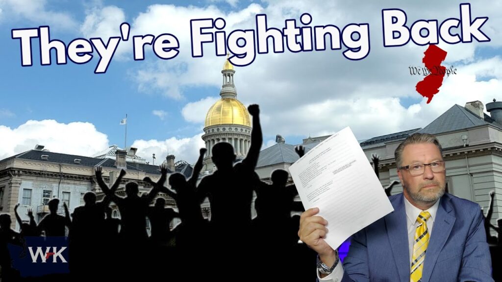 A man in a suit holds up papers in front of a government building with a gold dome. Behind him are silhouettes of people with raised fists and the text "They're Fighting Back" at the top. The state of New Jersey is shown in red.