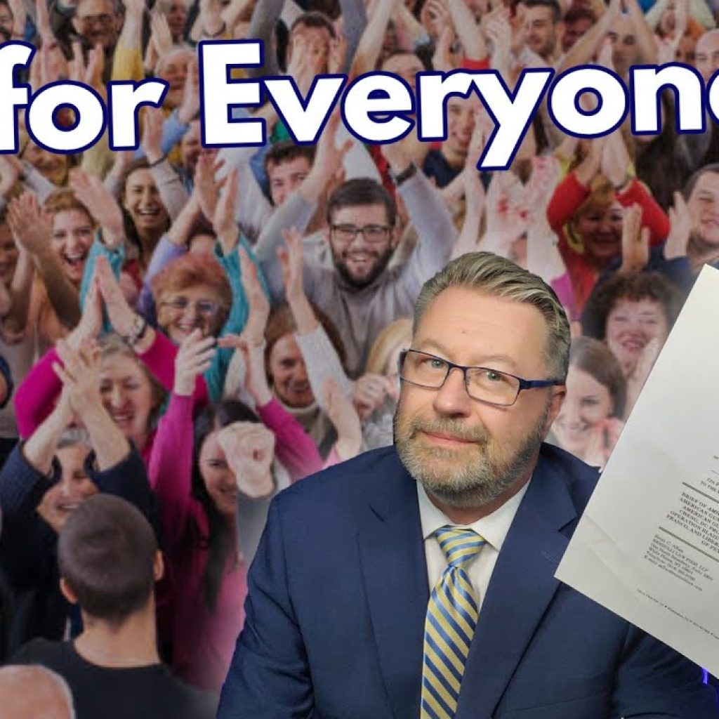 A man in a suit and glasses holds up a paper with "Everybody is welcome" written on it, standing in front of a cheering, diverse crowd. Large text above him reads, “It Is for Everyone!!!”.