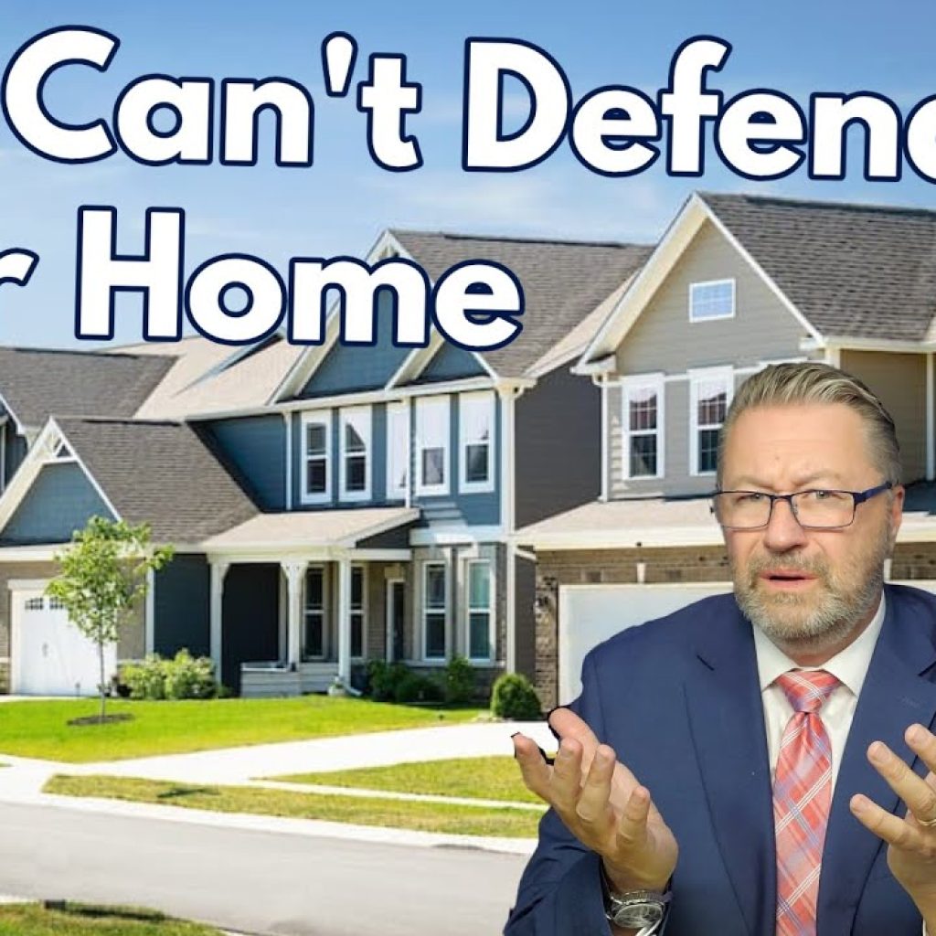 A man in a suit gestures while sitting in front of a row of suburban houses. Large text reads, "You Can't Defend Your Home." A "WK" logo with a map appears in the corner.