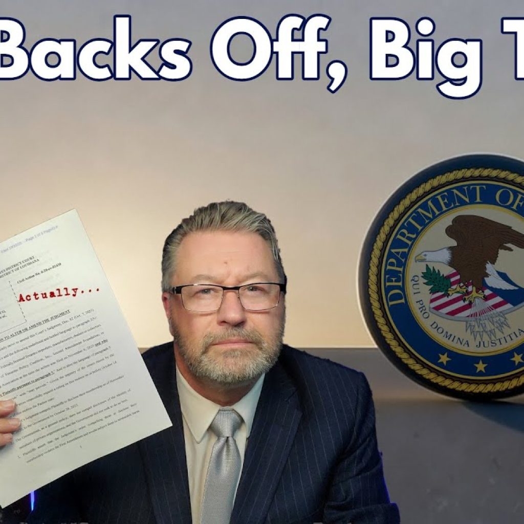 A man in a suit holds up a document labeled "Actually..." in front of a Department of Justice seal. Large text above reads "DOJ Backs Off, Big Time." The WK logo is in the corner of the image.