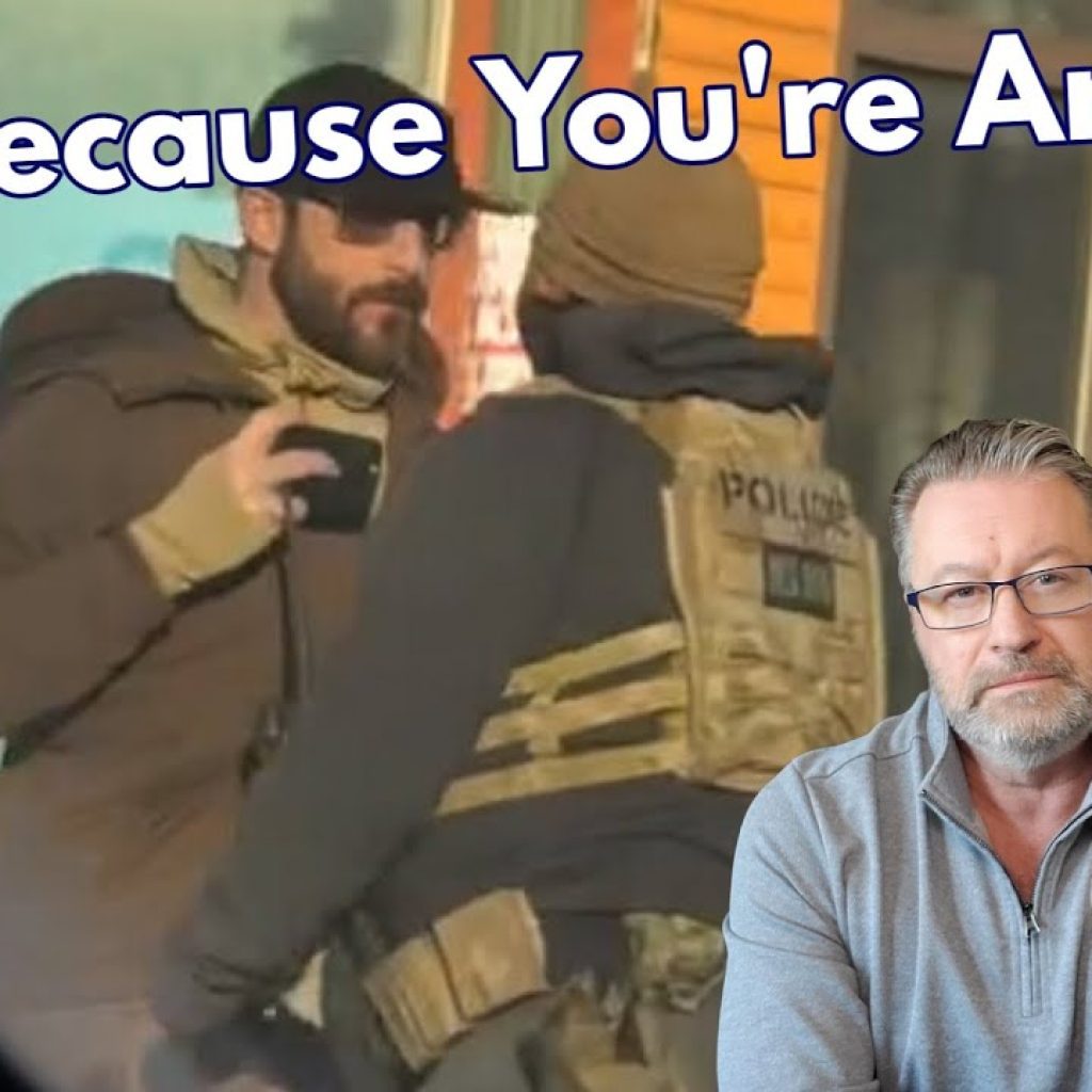 A bearded man in sunglasses speaks with a police officer in tactical gear. Large text reads "Just Because You're Armed?" In the corner, a serious-looking man in glasses and a gray WK shirt is pictured with a blue WK logo.
