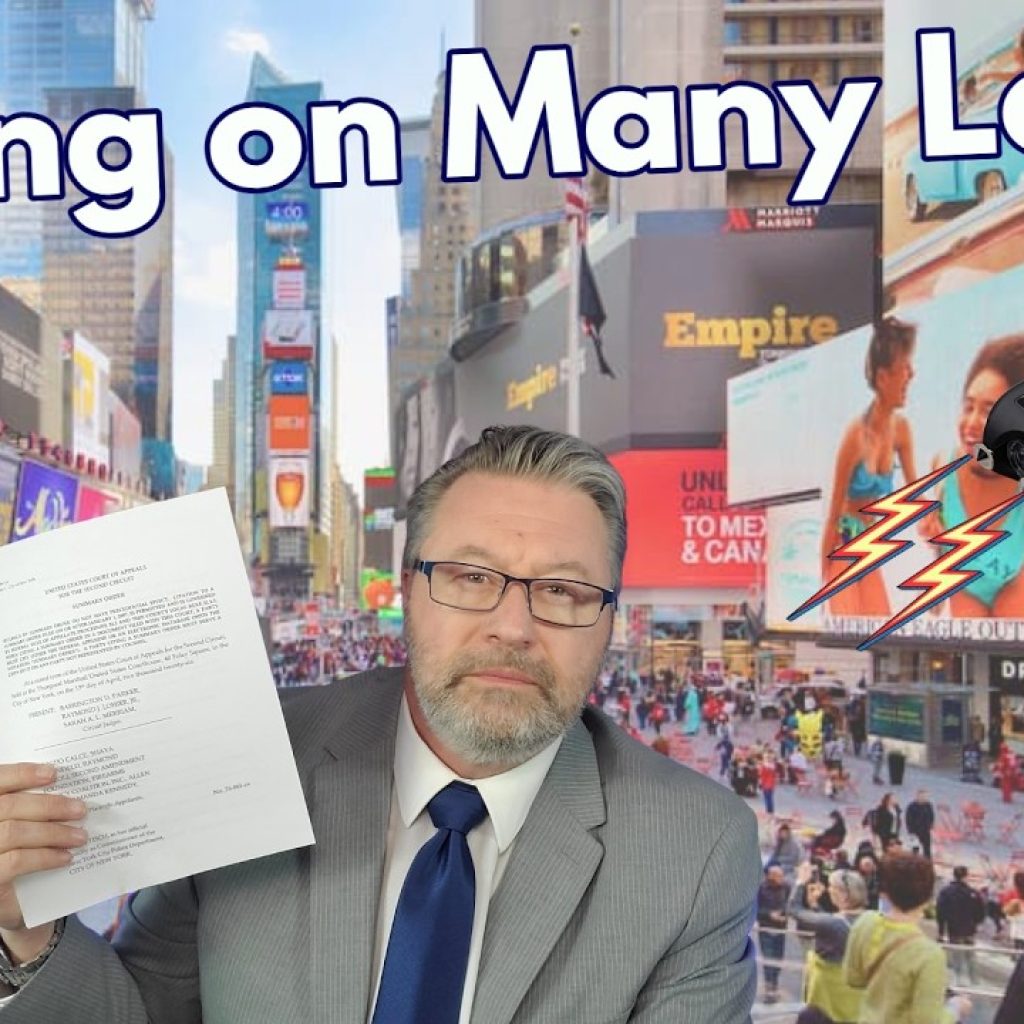 A man in a suit holds up papers with a serious expression in front of a busy Times Square background. The text "Wrong on Many Levels" is at the top, with a taser emitting sparks and a "WK" logo in the bottom left corner.